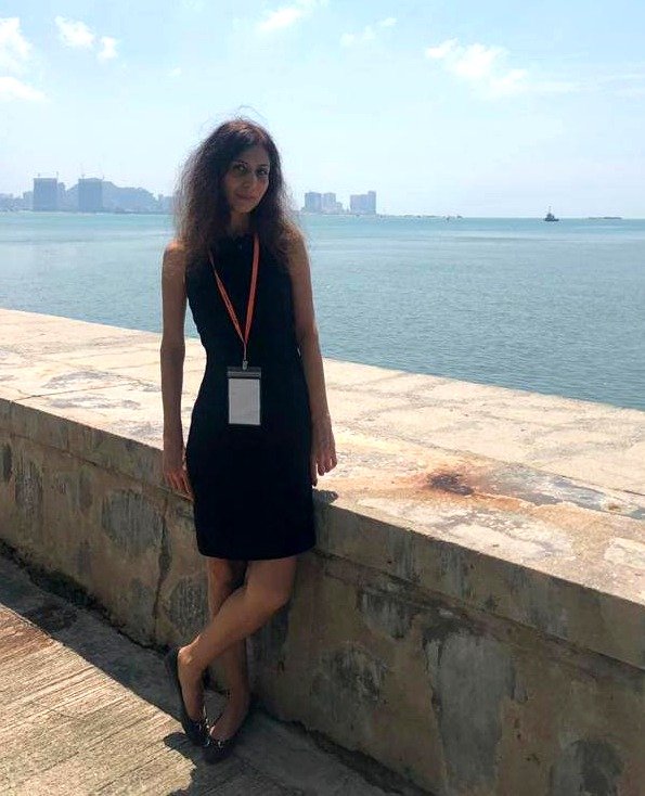 Melica Mahmoudi by the waterfront during an international education event
